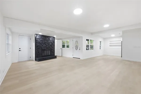 an empty room with windows and closet