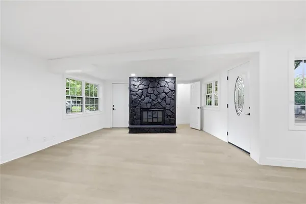 an empty room with windows and closet