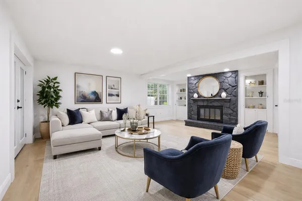 a living room with furniture and a fireplace