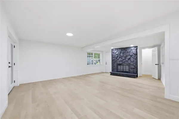 an empty room with windows and closet