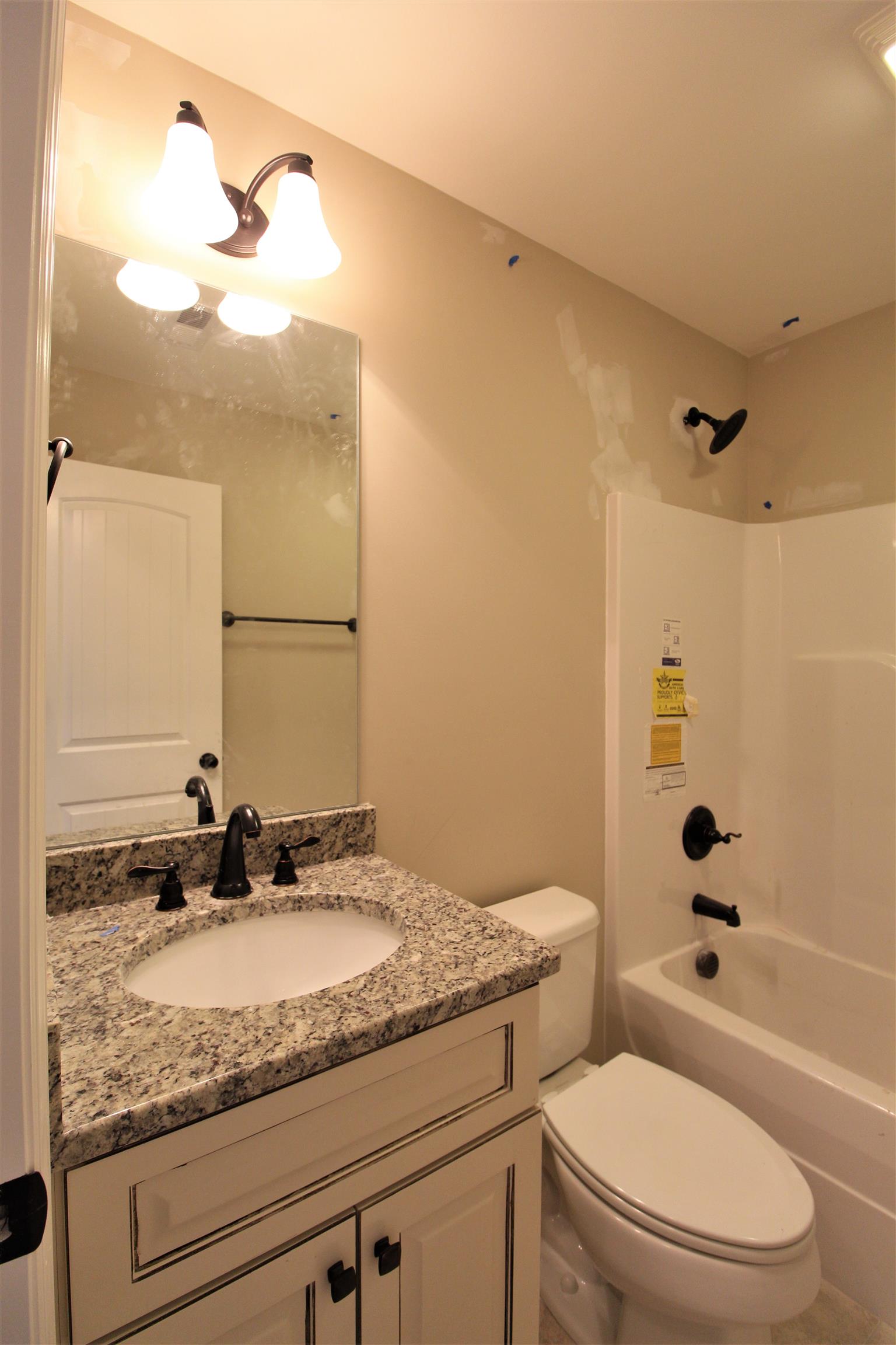 2521 Turner Road Watertown, TN 37184 - Photo 17 of 23 a bathroom with a granite countertop sink a toilet and a mirror