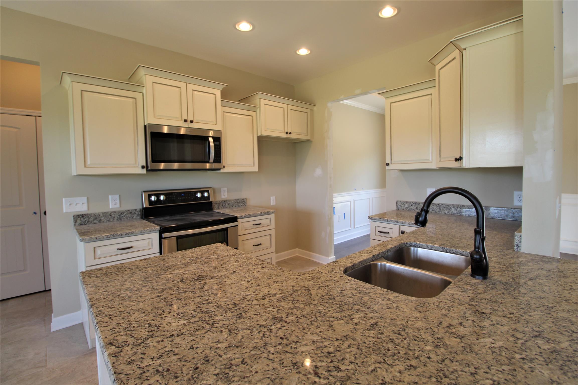 2521 Turner Road Watertown, TN 37184 - Photo 8 of 23 a kitchen with stainless steel appliances a stove a sink a microwave a refrigerator and cabinets