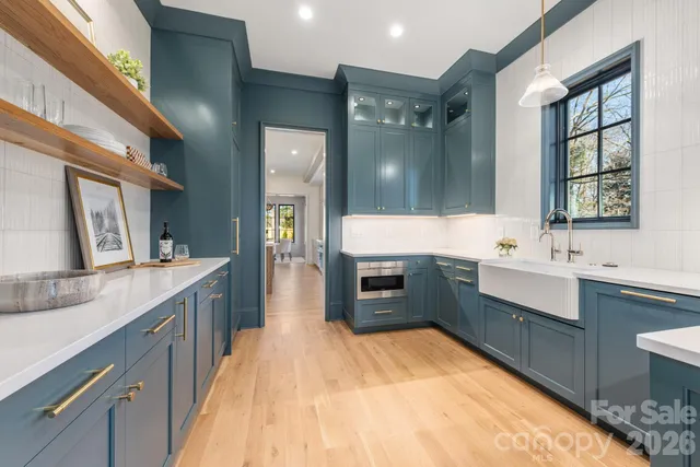 a large bathroom with a sink mirror and a bath tub
