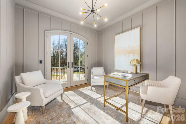 a living room with furniture a table and a large window