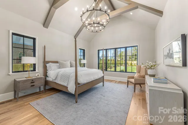 a bed room with a bed and a chandelier