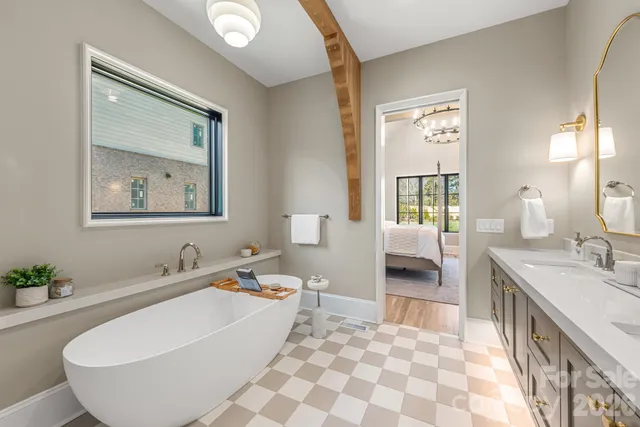 a bathroom with a tub sink and mirror