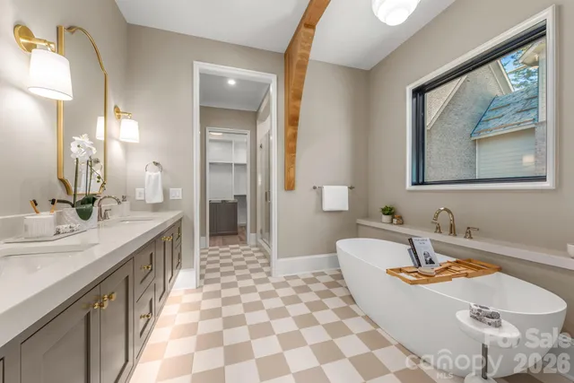 a spacious bathroom with a tub sink and mirror