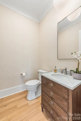 a bathroom with a granite countertop sink a toilet and a mirror