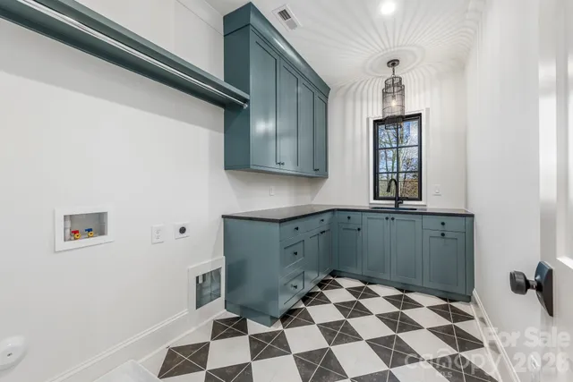 a kitchen with a checkered floor and cabinets