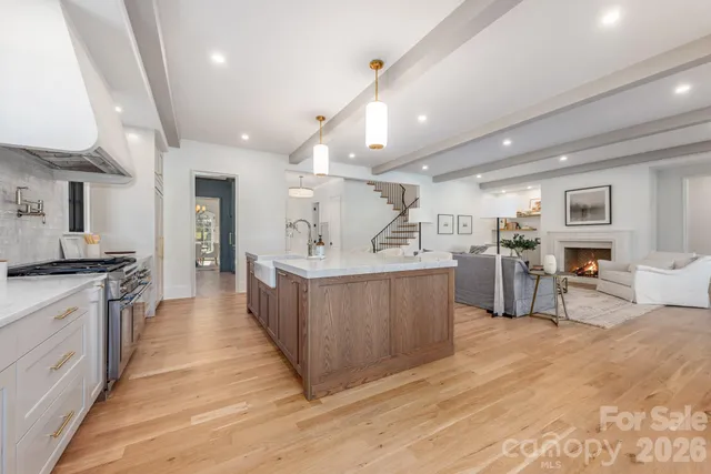 a large kitchen with stainless steel appliances a large counter top and a stove