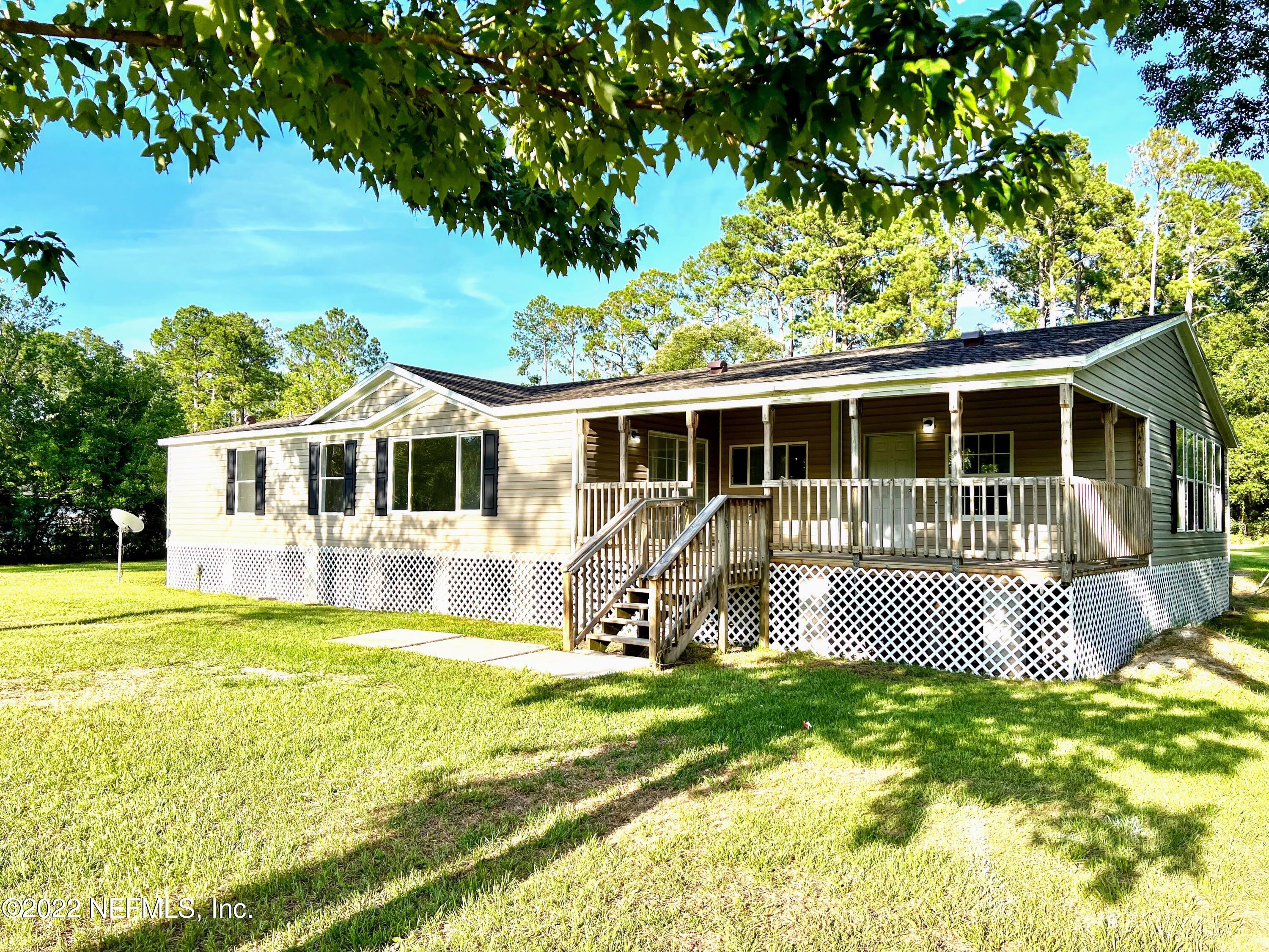 54176 Armstrong Road Callahan, FL 32011 - Photo 1 of 30 a front view of a house with a yard