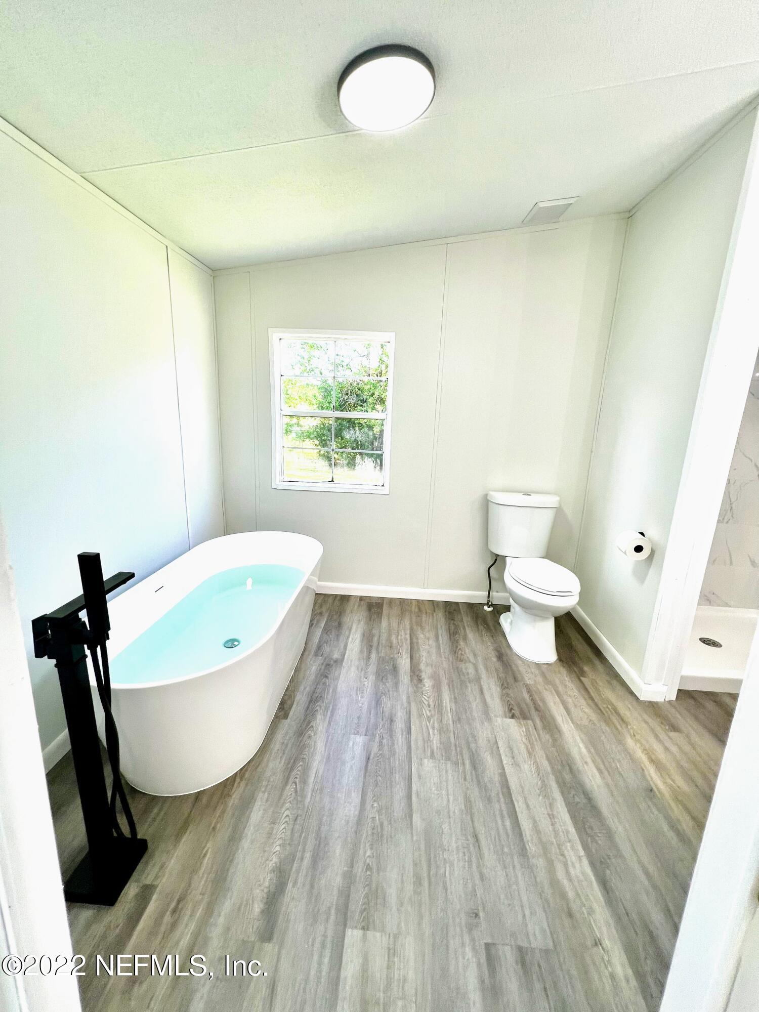 54176 Armstrong Road Callahan, FL 32011 - Photo 18 of 30 a bathroom with a sink and a bathtub
