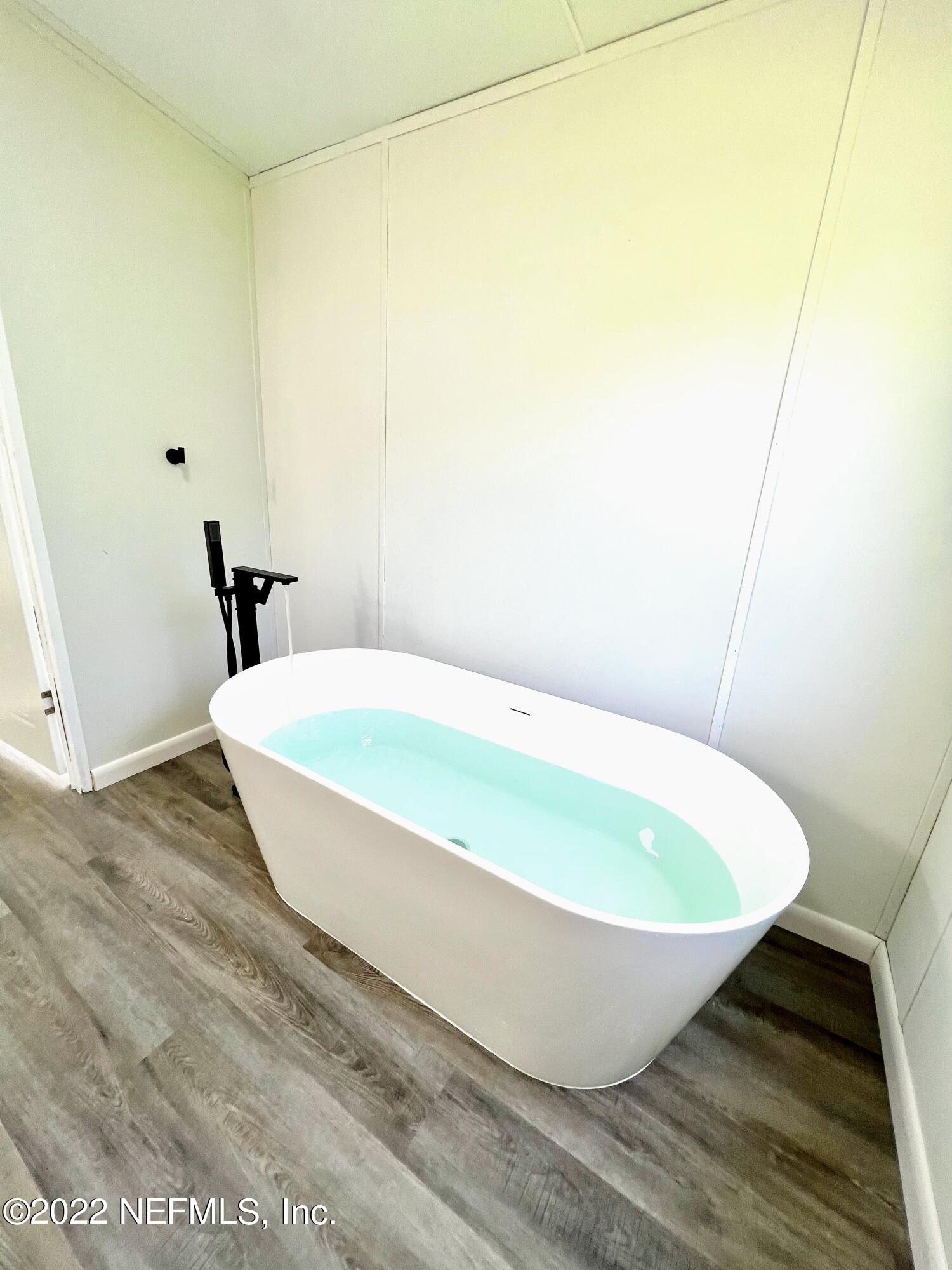 54176 Armstrong Road Callahan, FL 32011 - Photo 20 of 30 a white tub sitting next to a small white sink