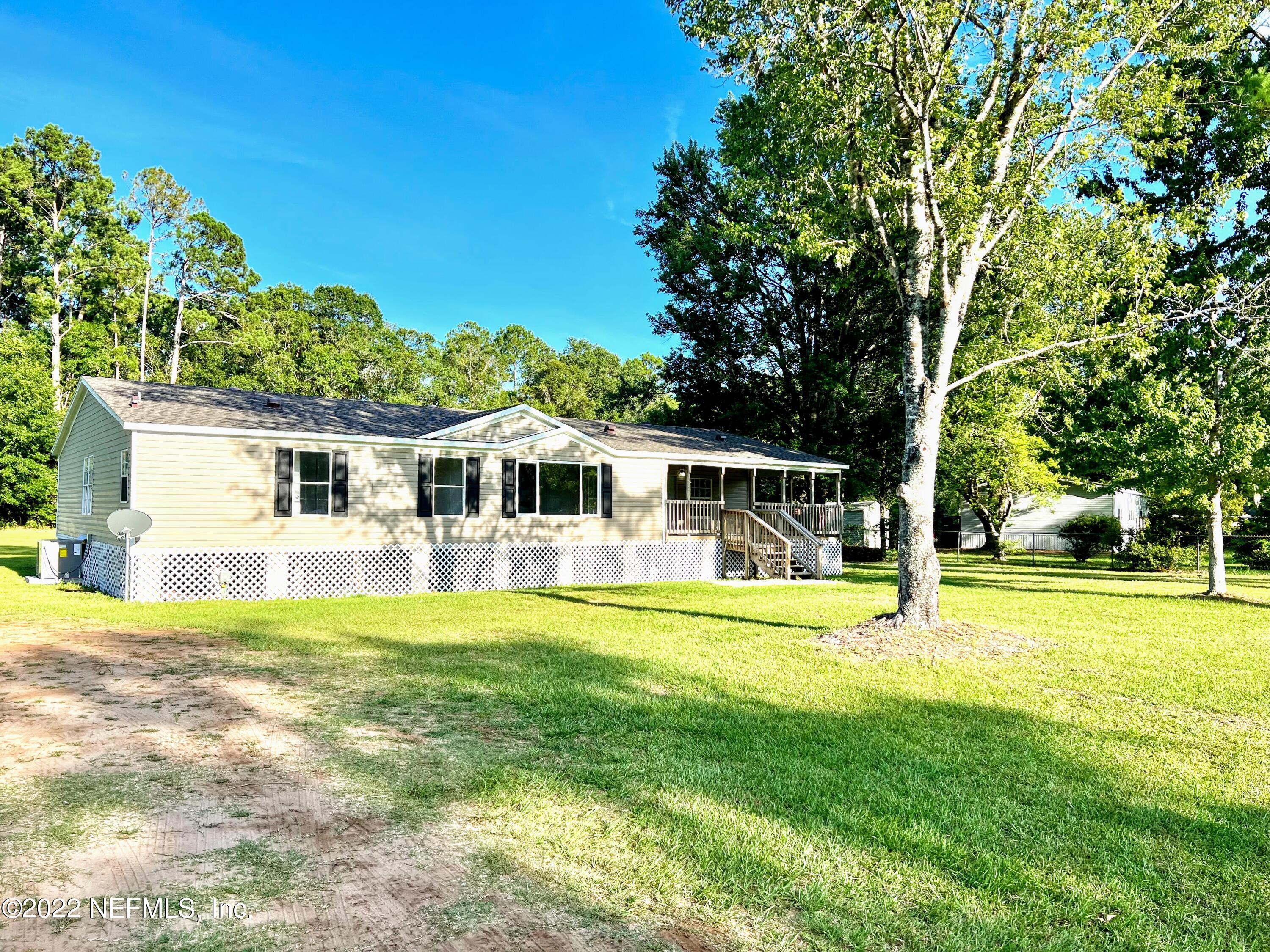 54176 Armstrong Road Callahan, FL 32011 - Photo 2 of 30 a front view of a house with a big yard