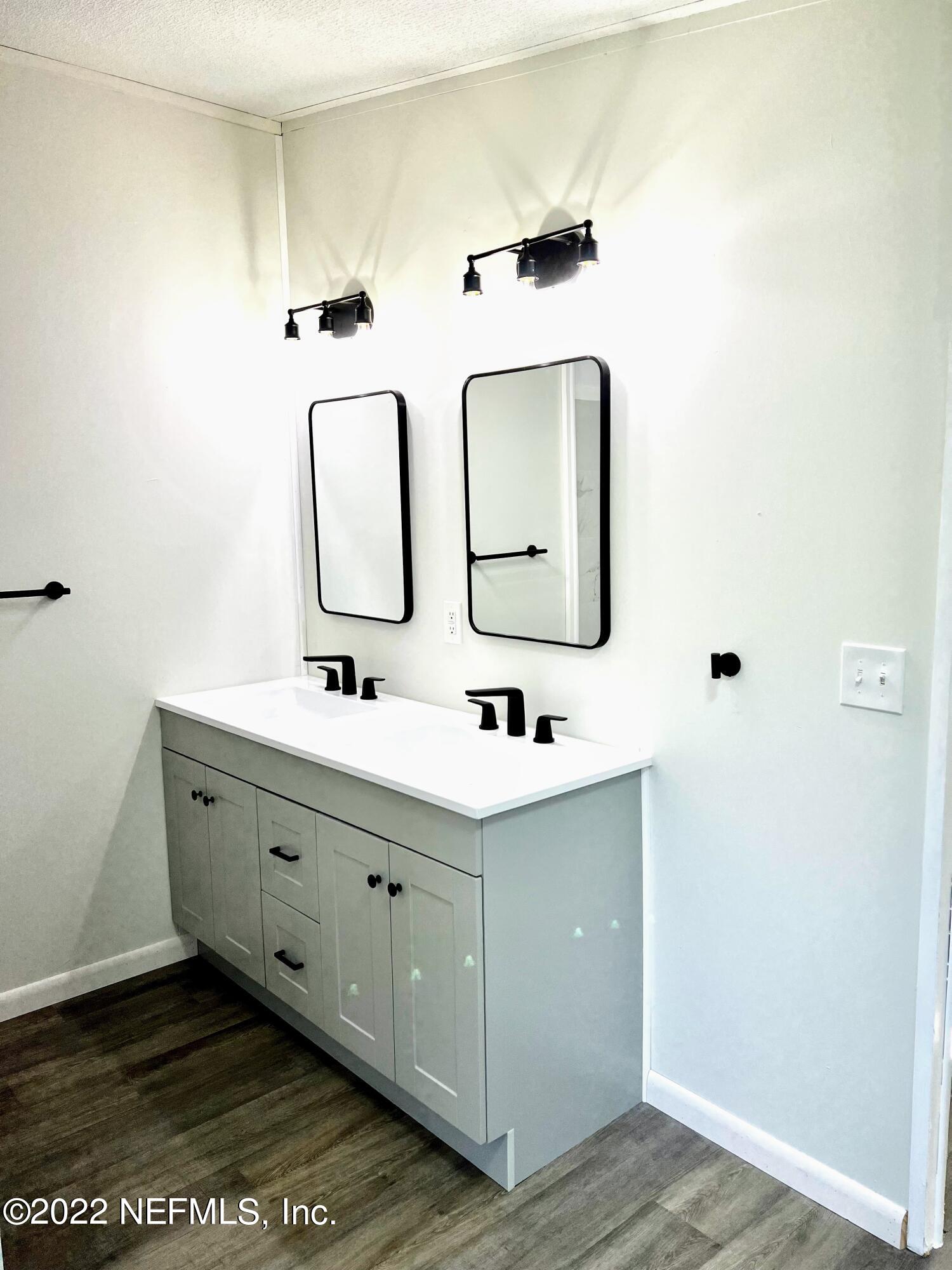 54176 Armstrong Road Callahan, FL 32011 - Photo 21 of 30 a bathroom with a double vanity sink mirror and