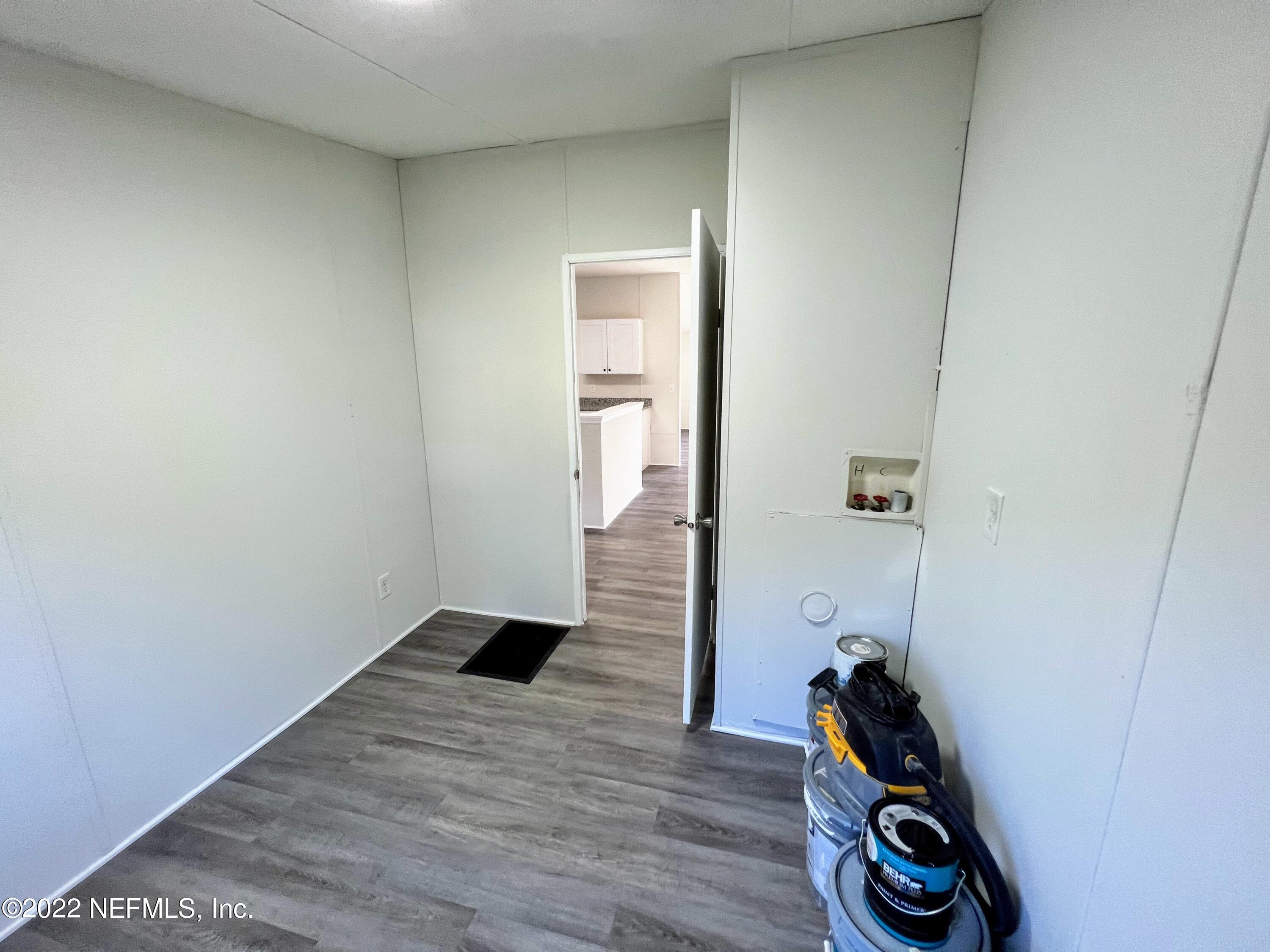 54176 Armstrong Road Callahan, FL 32011 - Photo 27 of 30 an empty room with wooden floor and closet
