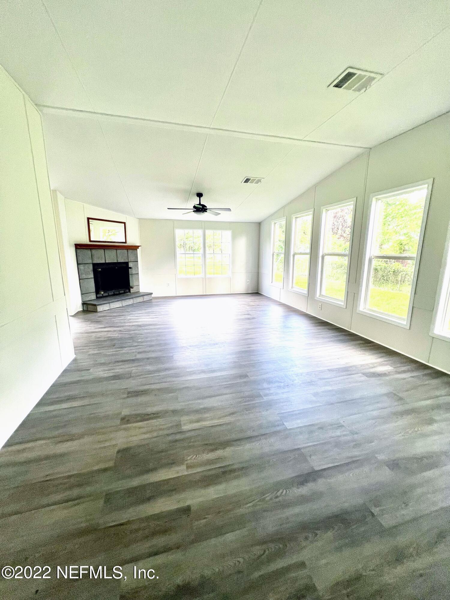 54176 Armstrong Road Callahan, FL 32011 - Photo 5 of 30 a view of an empty room with a window and fireplace