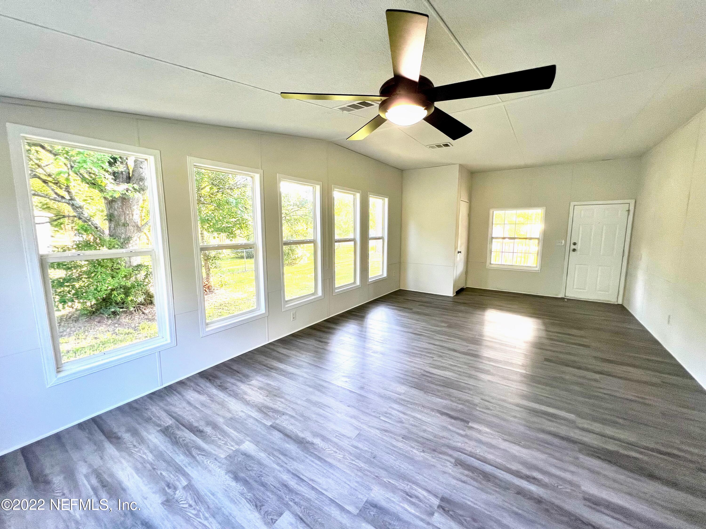 54176 Armstrong Road Callahan, FL 32011 - Photo 6 of 30 a view of an empty room with wooden floor and a window