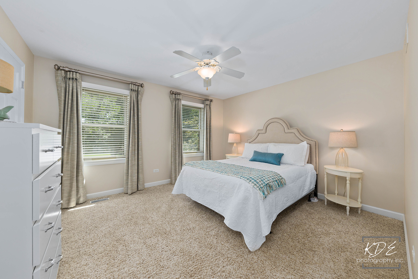 1403 Carlyle Road Naperville, IL 60564 - Photo 17 of 31 a bedroom with a large bed and a chandelier