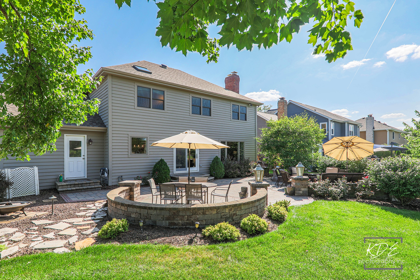 1403 Carlyle Road Naperville, IL 60564 - Photo 27 of 31 a front view of a house with a yard fire pit table and chairs