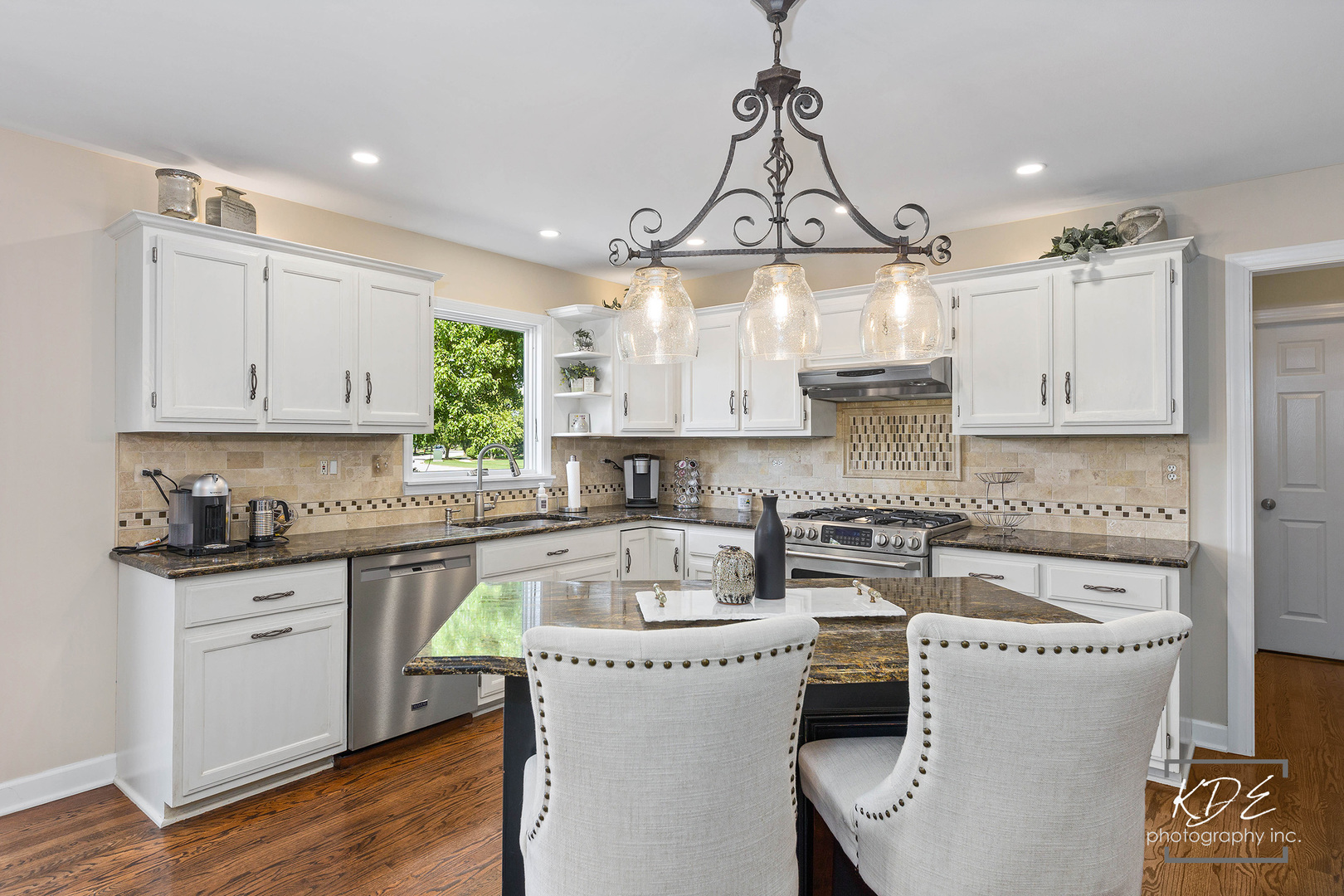 1403 Carlyle Road Naperville, IL 60564 - Photo 6 of 31 a kitchen that has a lot of cabinets in it and wooden floors