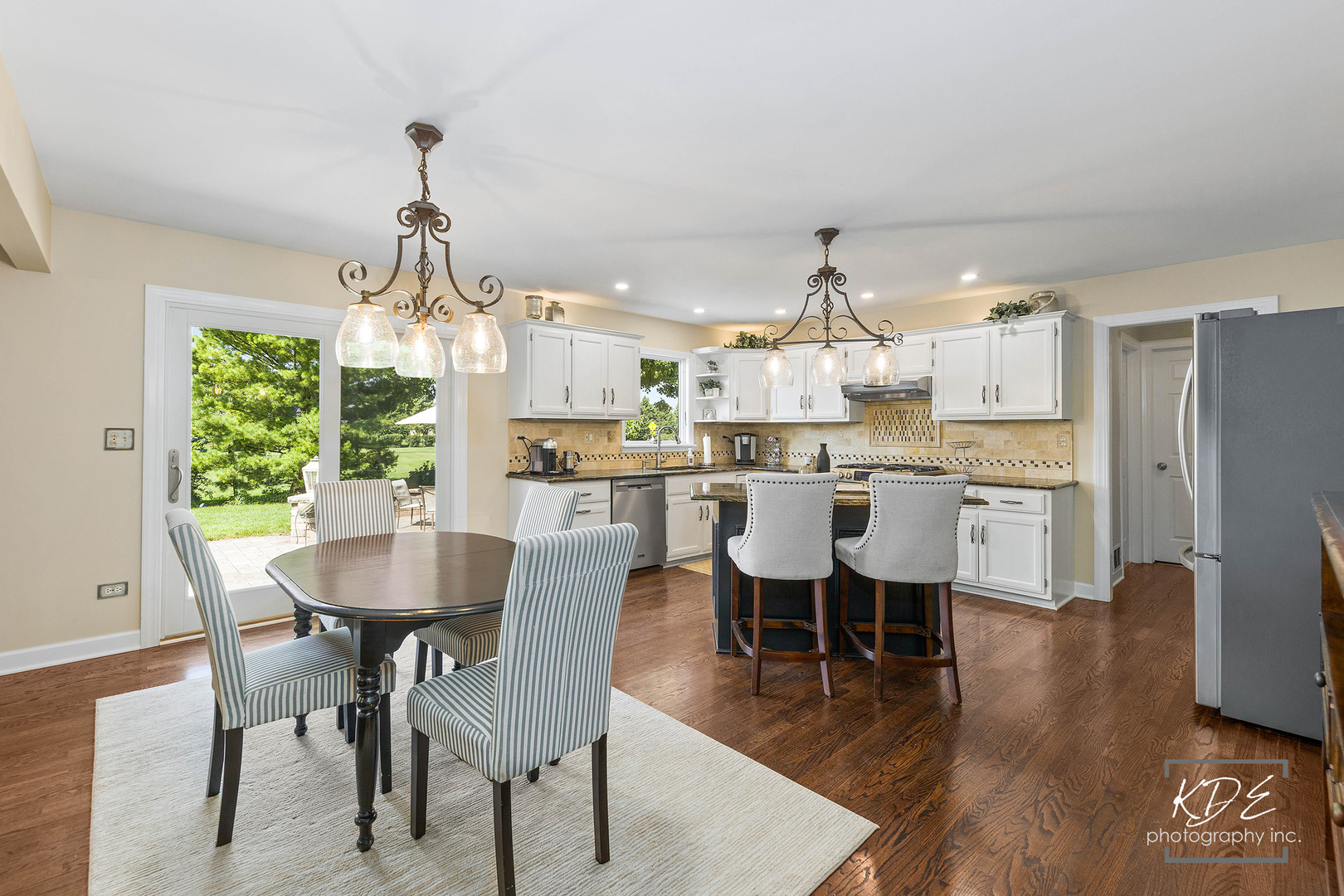 1403 Carlyle Road Naperville, IL 60564 - Photo 7 of 31 a view of a dining room and livingroom with furniture wooden floor a chandelier