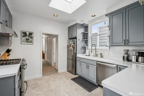 a kitchen with stainless steel appliances granite countertop a stove and a sink