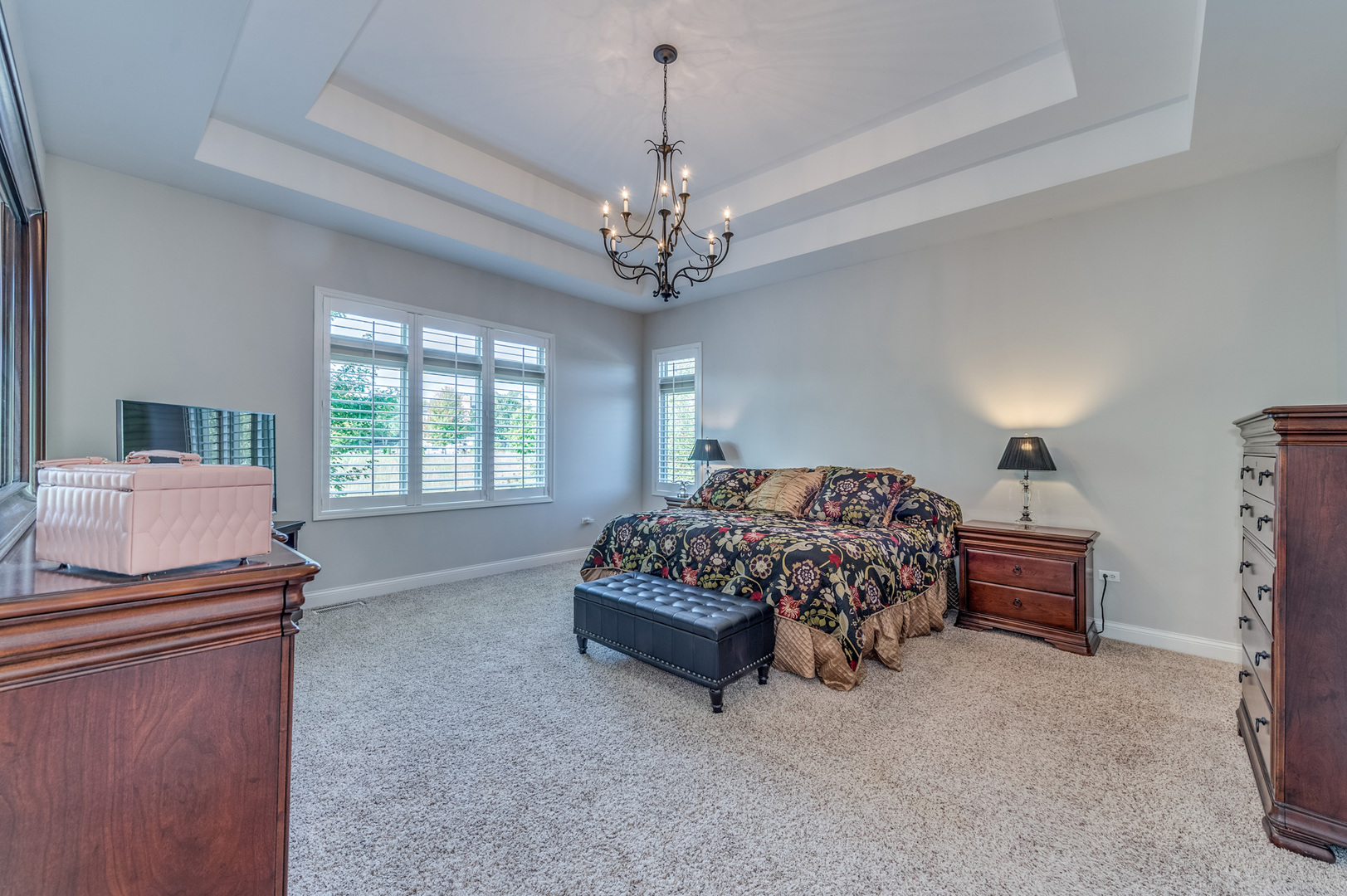 2918 Hapner Way Batavia, IL 60510 - Photo 21 of 43 a spacious bedroom with a bed and a chandelier
