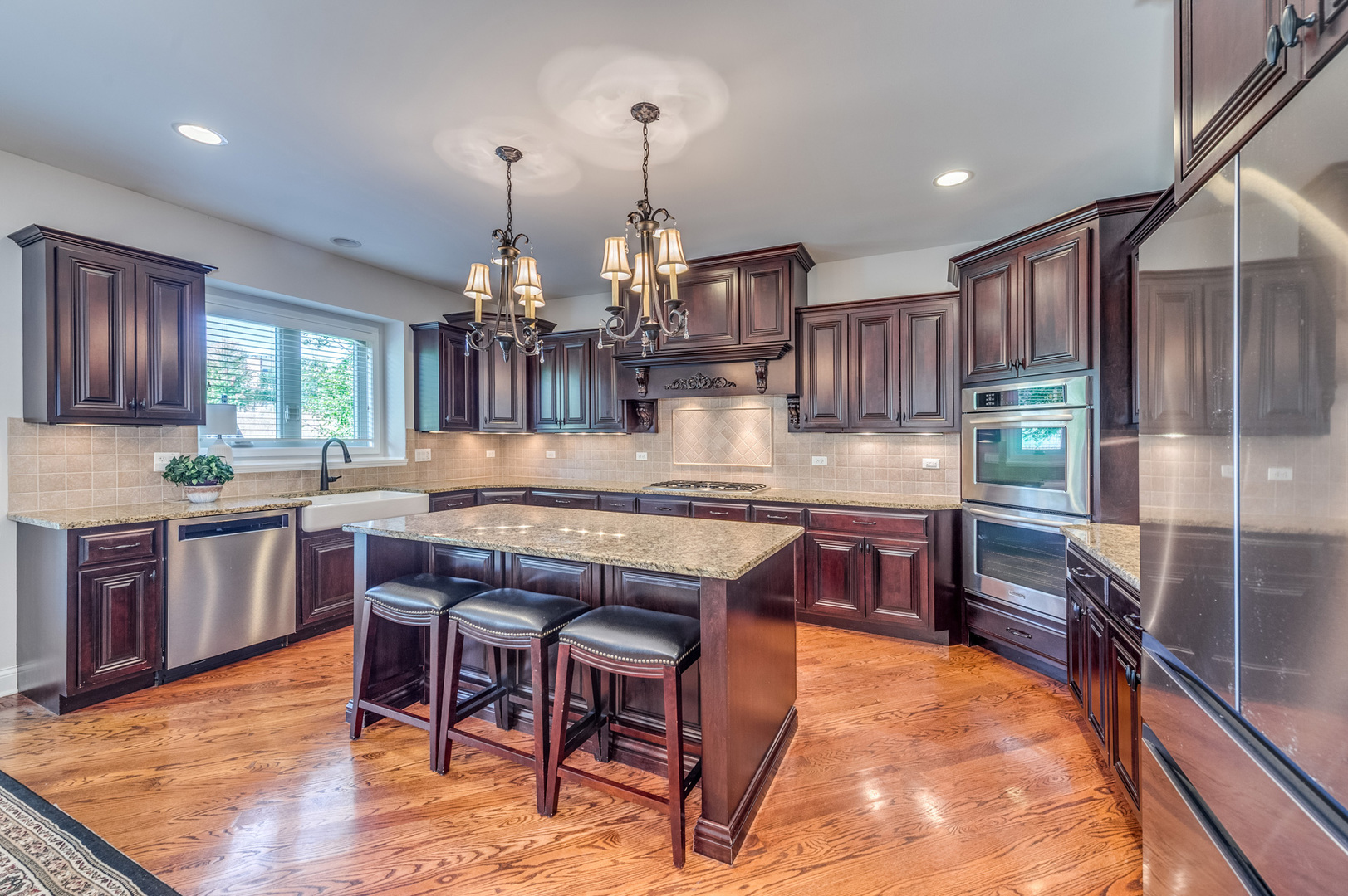 2918 Hapner Way Batavia, IL 60510 - Photo 10 of 43 a kitchen with kitchen island granite countertop wooden cabinets and center island