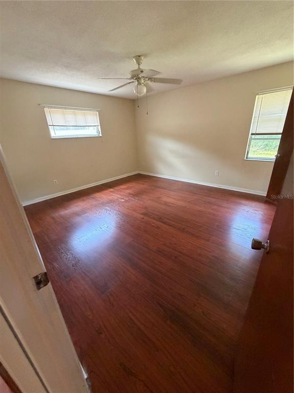 517 London Road Winter Park, FL 32792 - Photo 8 of 13 an empty room with wooden floor fan and windows