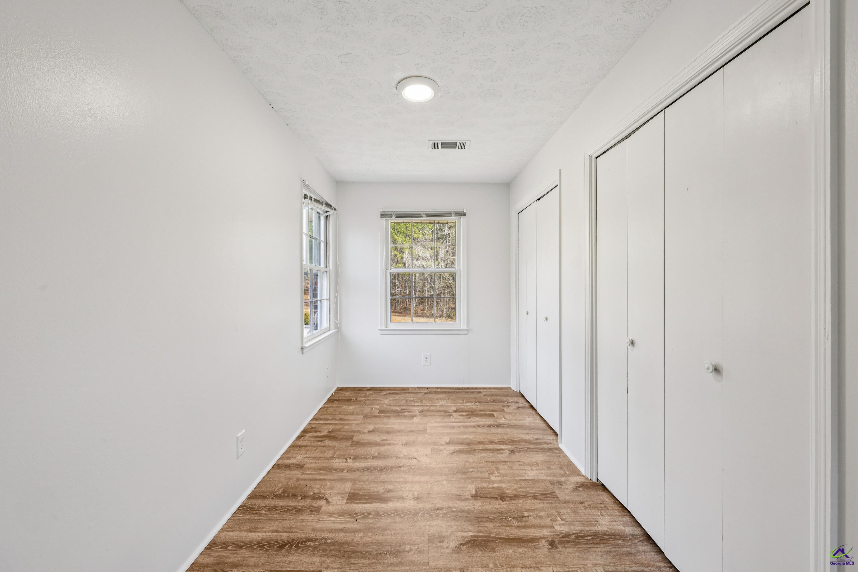 548 Greene Settlement Road Gray, GA 31032 - Photo 24 of 68 a view of a hallway with wooden floor and a window