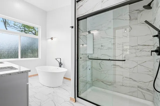 a bathroom with a bathtub and a shower