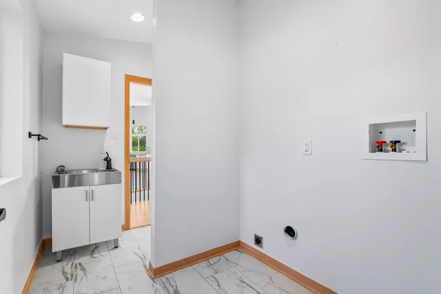 a view of a room with wooden floor and a window