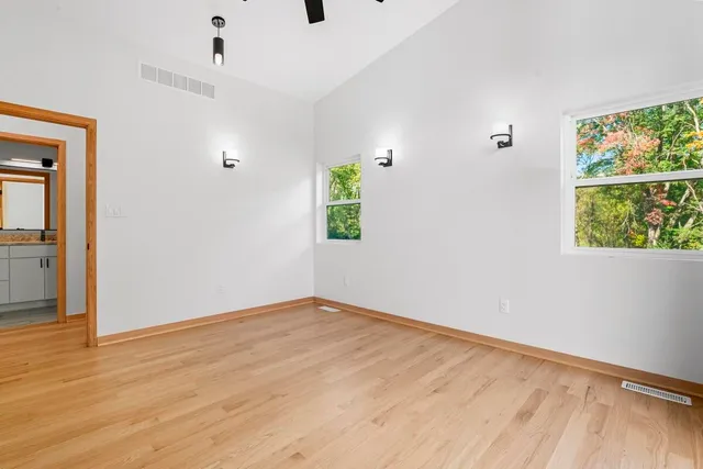 wooden floor in an empty room with a window