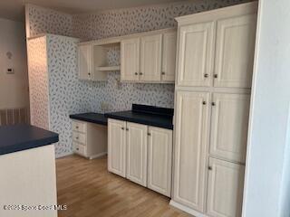 5361 Bison Street, Unit P19 Micco, FL 32976 - Photo 17 of 27 a kitchen with a refrigerator and white cabinets