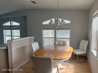 5361 Bison Street, Unit P19 Micco, FL 32976 - Photo 19 of 27 a view of a dining room with furniture wooden floor and a chandelier