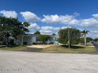 5361 Bison Street, Unit P19 Micco, FL 32976 - Photo 2 of 27 a view of a house with a yard and large trees