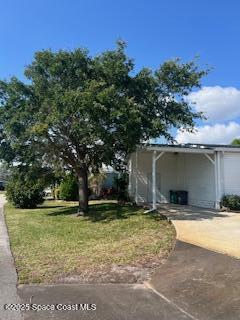 5361 Bison Street, Unit P19 Micco, FL 32976 - Photo 3 of 27 a house view with a garden space