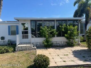 5361 Bison Street, Unit P19 Micco, FL 32976 - Photo 6 of 27 a house view with a garden space