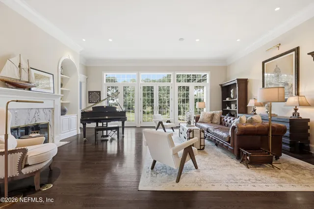 a living room with furniture and a floor to ceiling window