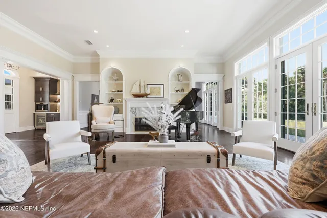 a living room with furniture and a floor to ceiling window
