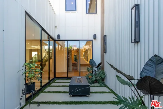 a kitchen with stainless steel appliances kitchen island a stove and a sink