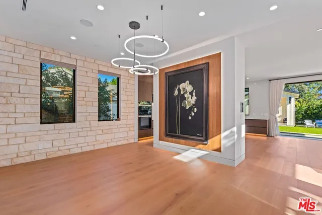 a living room with furniture a large window and a fireplace