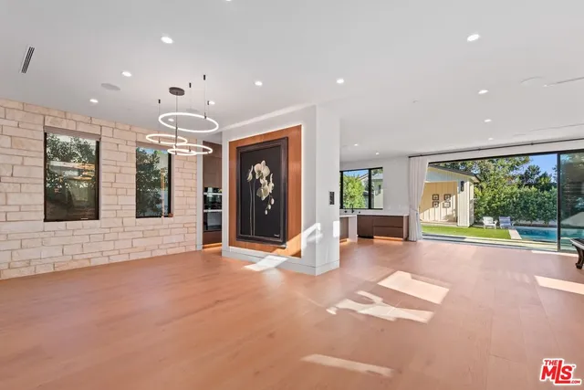a living room with fireplace furniture and a large window