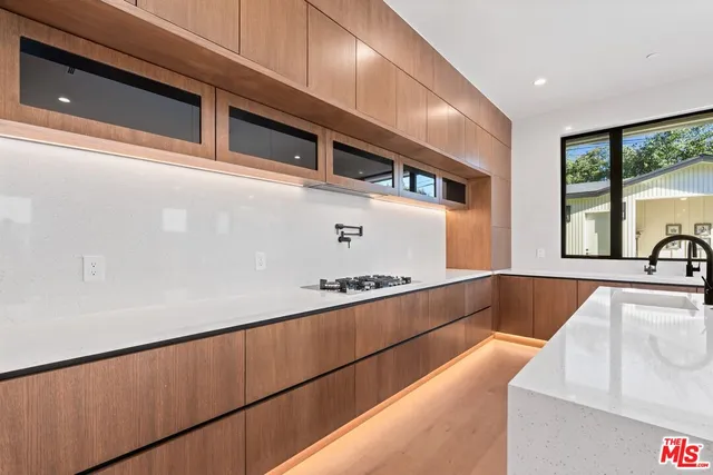 a view of an empty room with a fireplace and a window