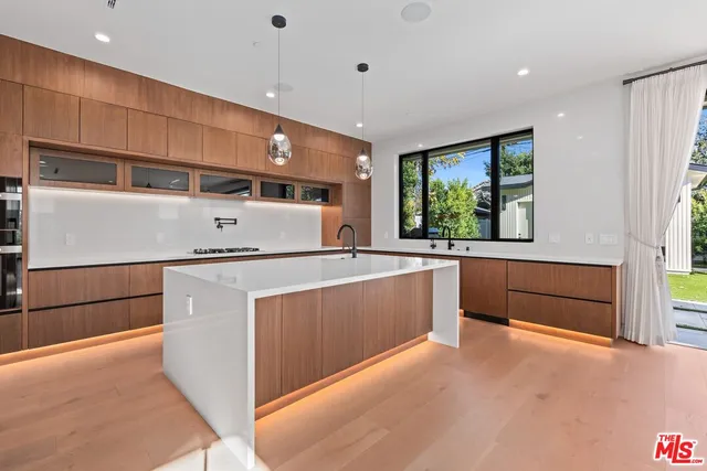 a view of a room with large windows and stairs