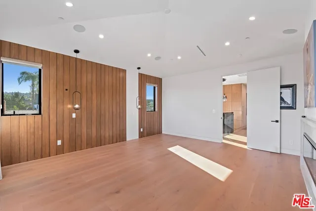 an empty room with windows and closet