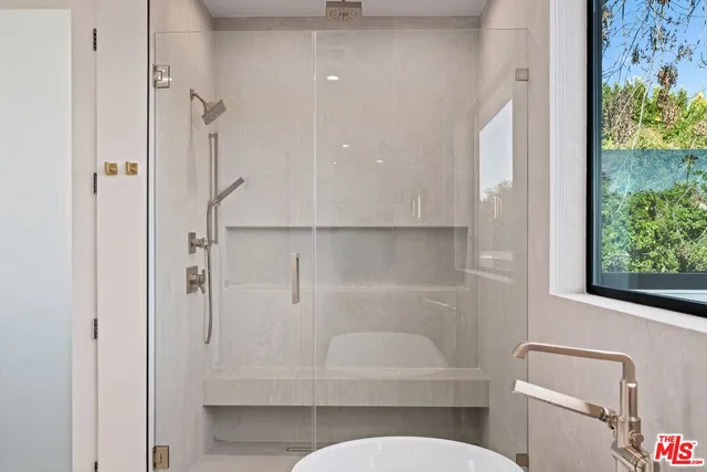 a view of house with swimming pool and glass windows