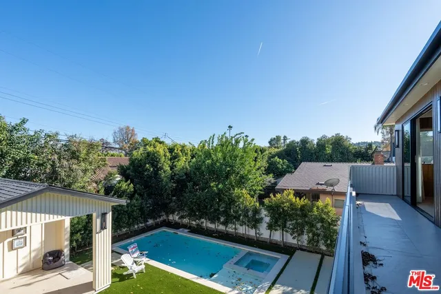 a bathroom with a sink vanity mirror and toilet