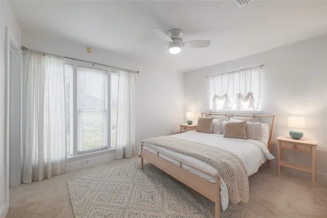 a bedroom with a large bed and a chandelier